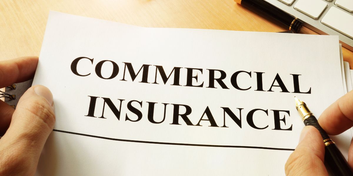 Commercial property insurance written on a paper with a pen